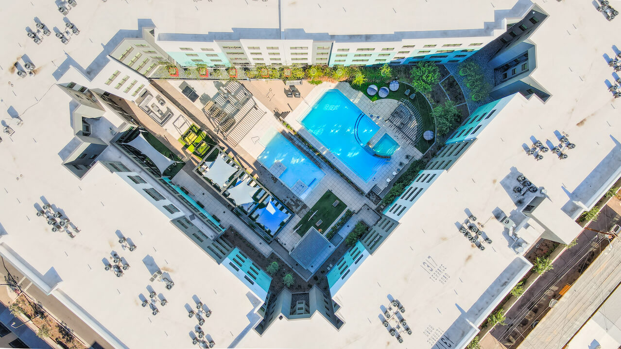Aerial view of a courtyard with pools and seating areas