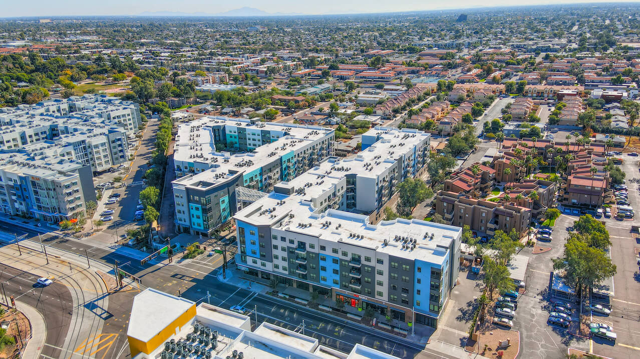 Aerial view of modern apartment buildings and surrounding neighborhood