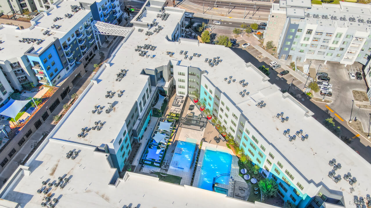 Aerial view of modern apartments with swimming pool and lounge area