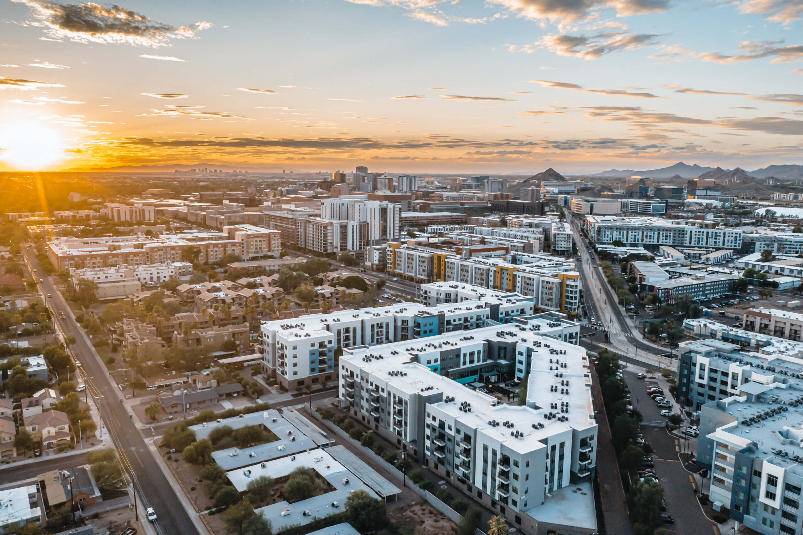 Aerial view of urban buildings at sunset scaled