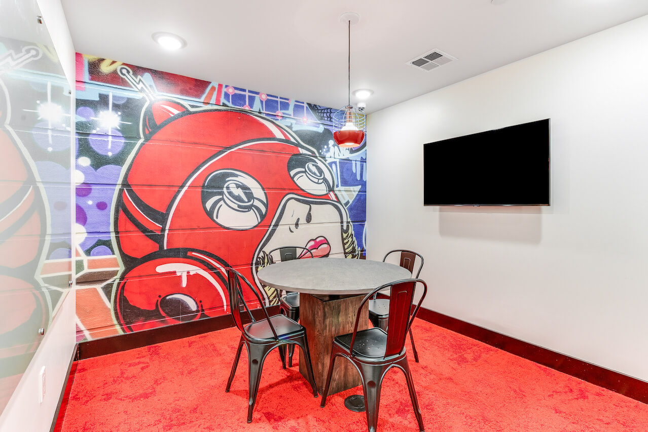 Colorful mural in a study room with a round table and chairs