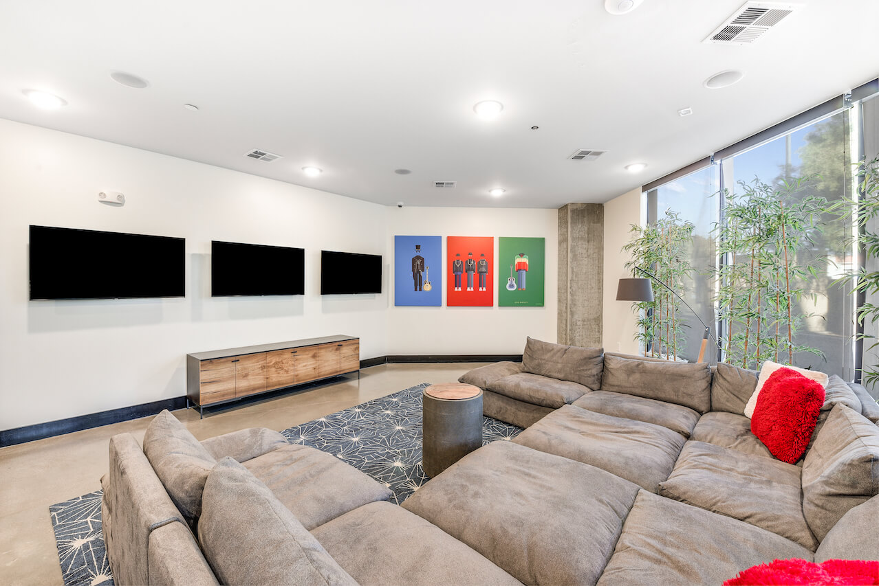 Cozy lounge area with sectional sofa and colorful artwork