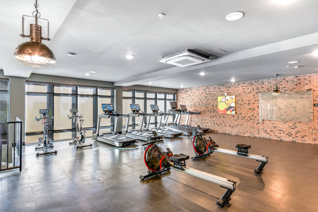Fitness center featuring rowing machines and cardio equipment