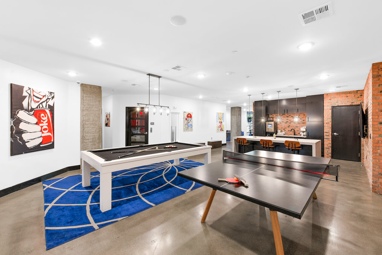 Game room with pool table ping pong table and modern decor