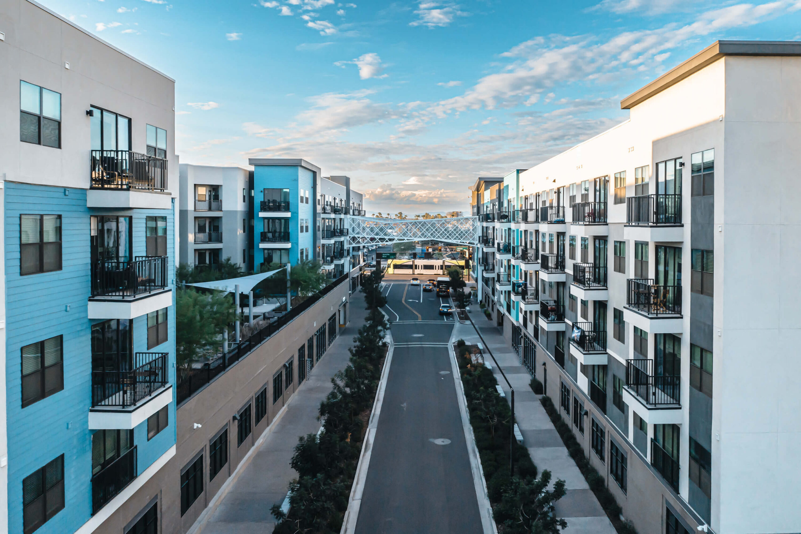 Modern apartment buildings lined along a quiet street scaled