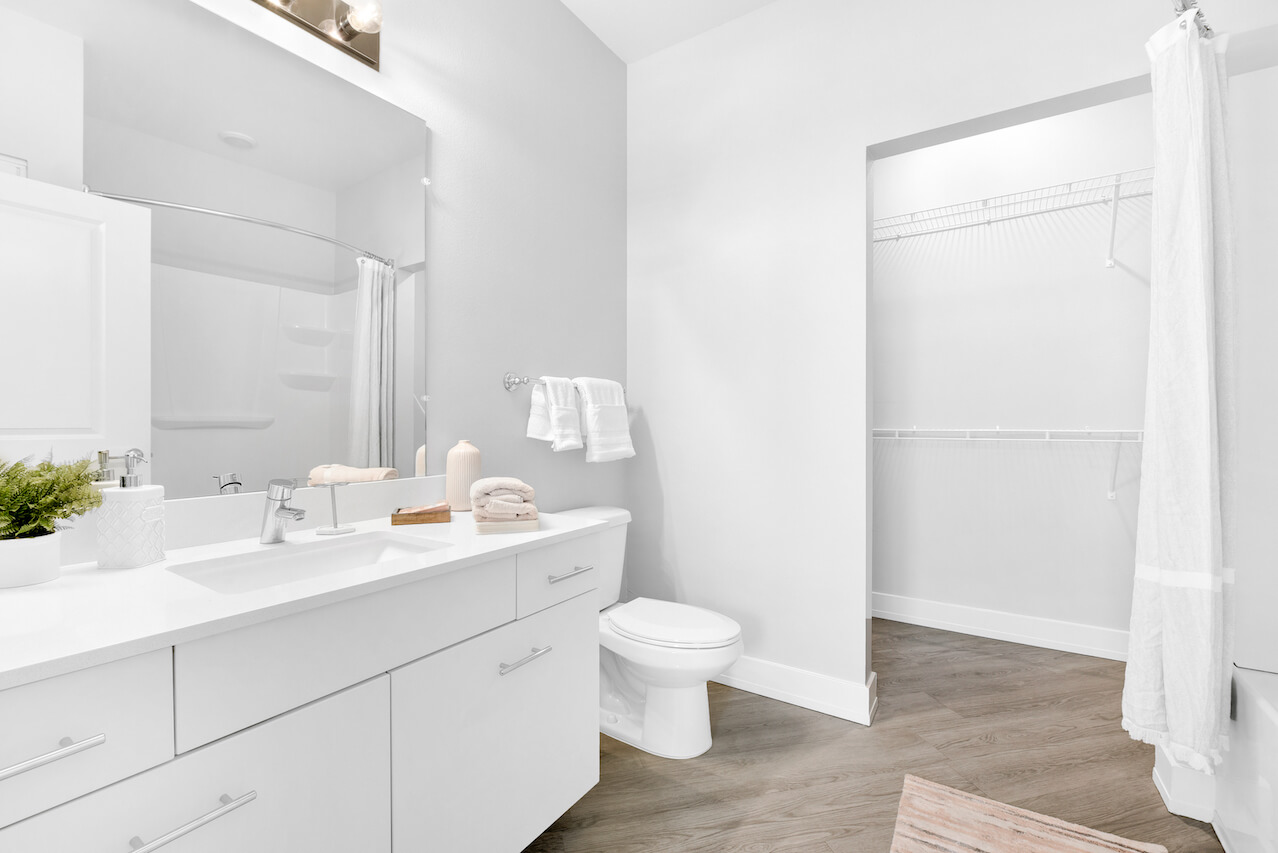 Modern bathroom with white fixtures and wood flooring