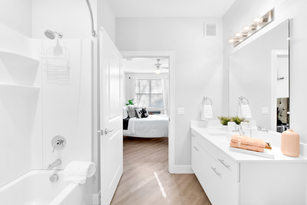 Modern bathroom with white walls shower and sink area