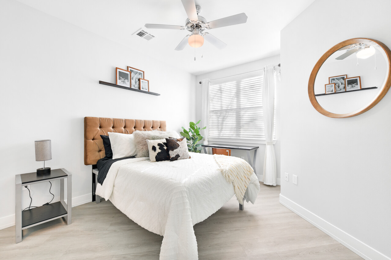 Modern bedroom with a tufted headboard and natural light