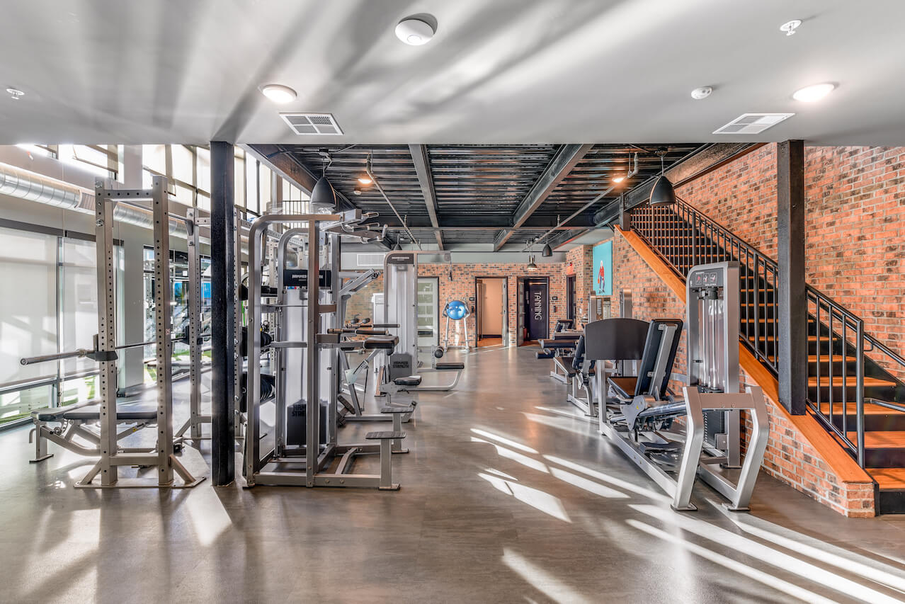 Modern fitness center with exercise equipment and stylish decor