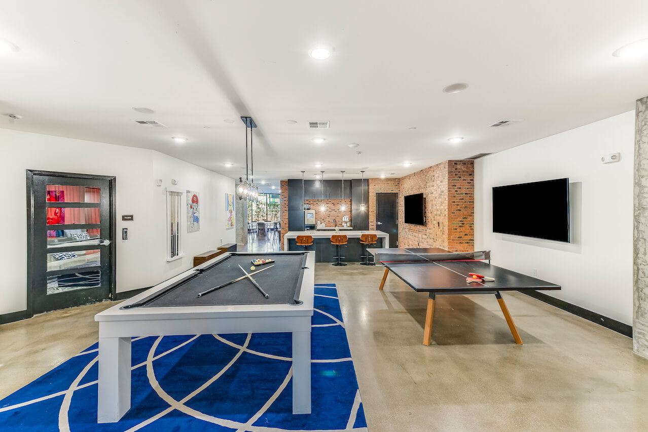 Modern game room with a pool table and kitchenette