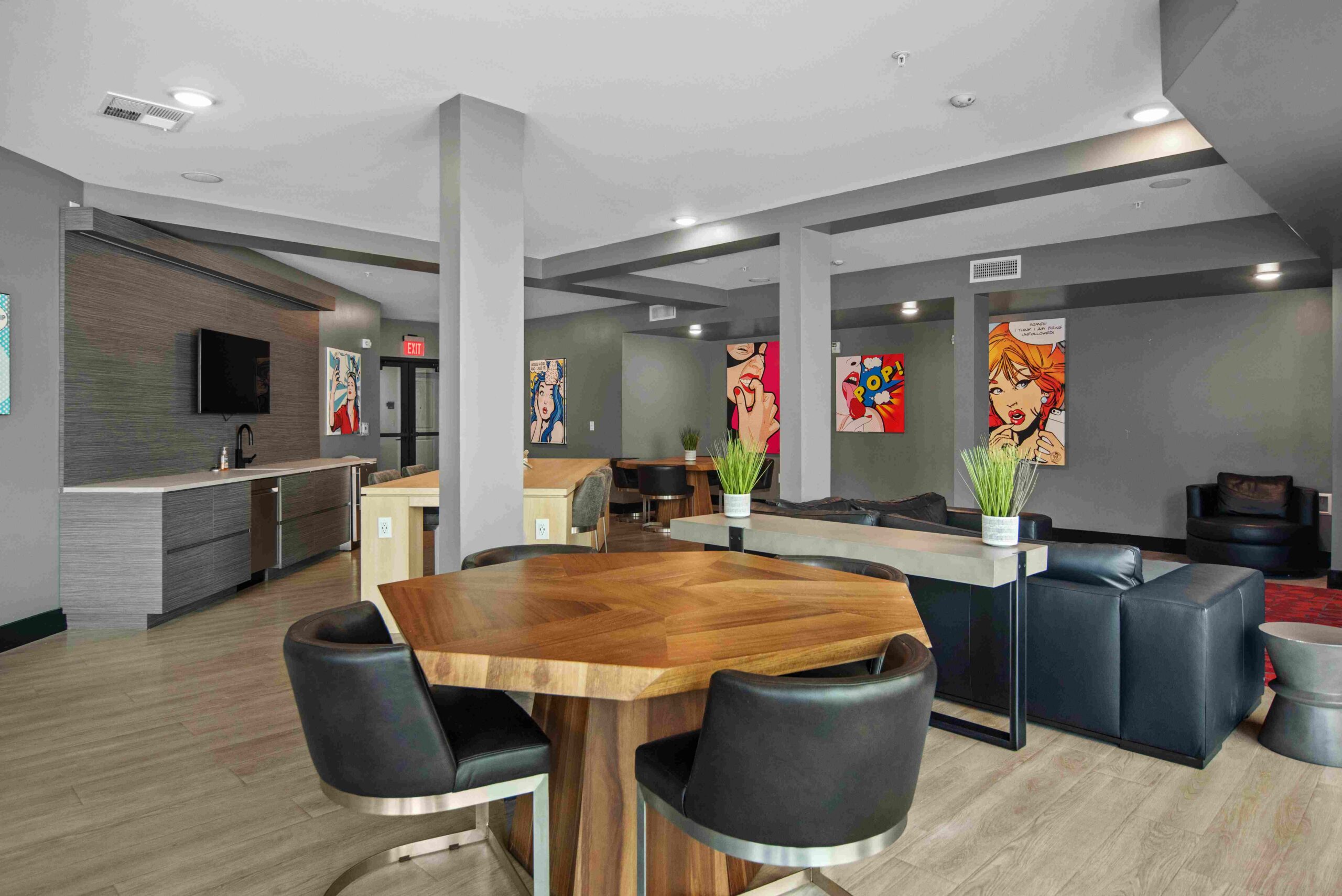 Modern lounge with art seating and a kitchenette scaled