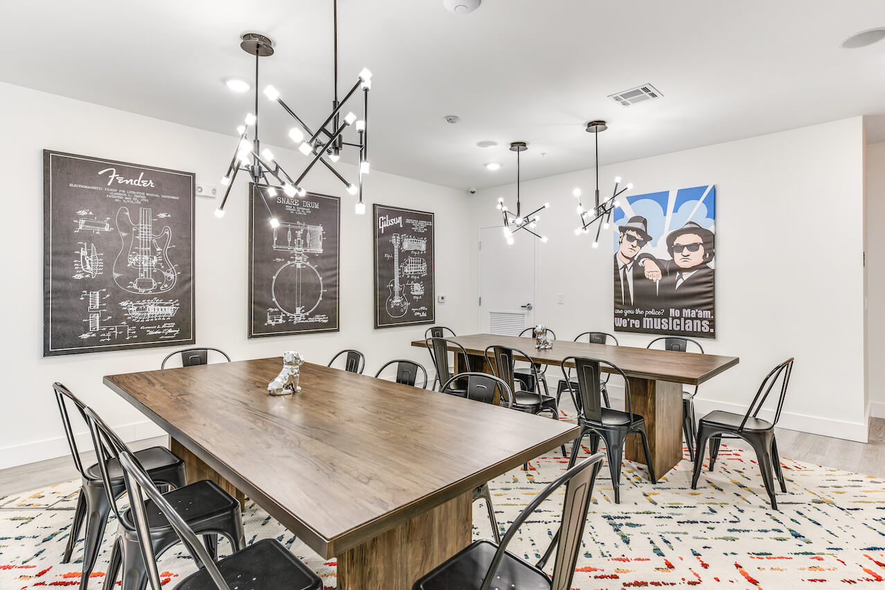 Modern study lounge with musical themed artwork and large wooden table