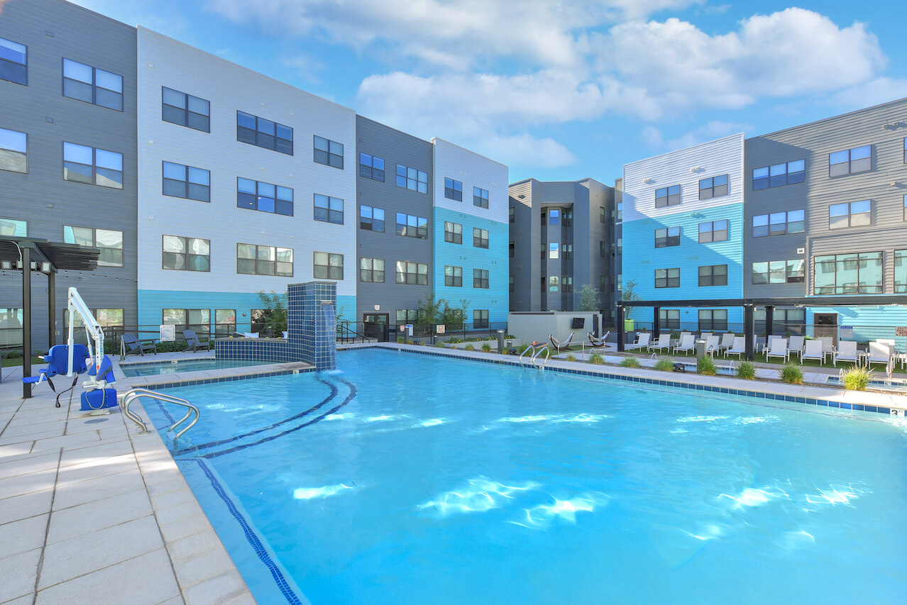 Swimming pool surrounded by modern apartment buildings