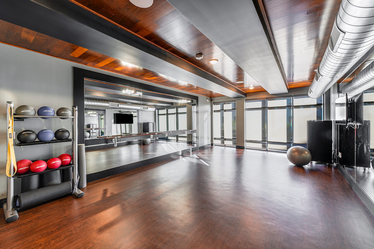 Yoga studio with exercise equipment and large mirrors