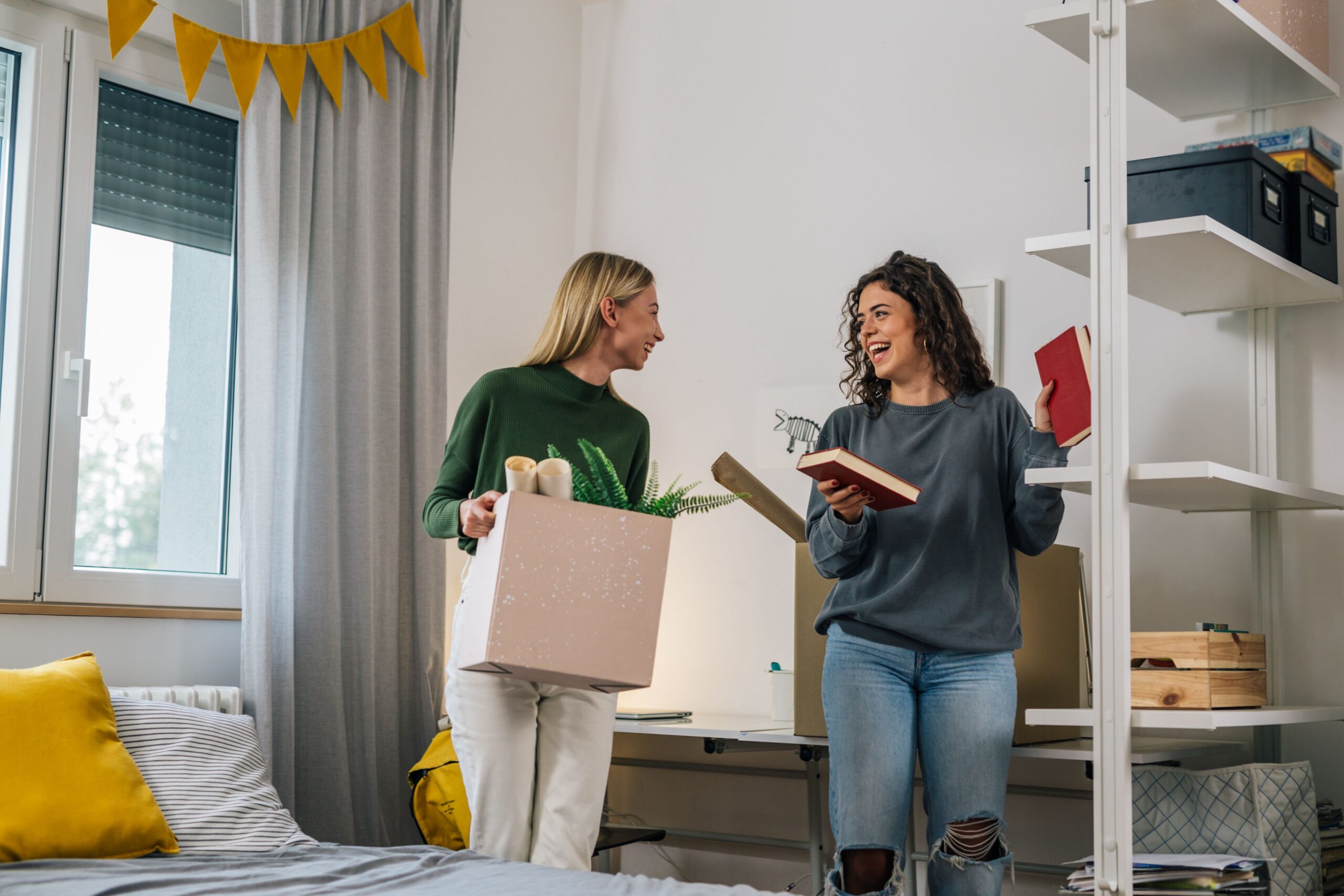 roommates unpacking boxes in apartment scaled